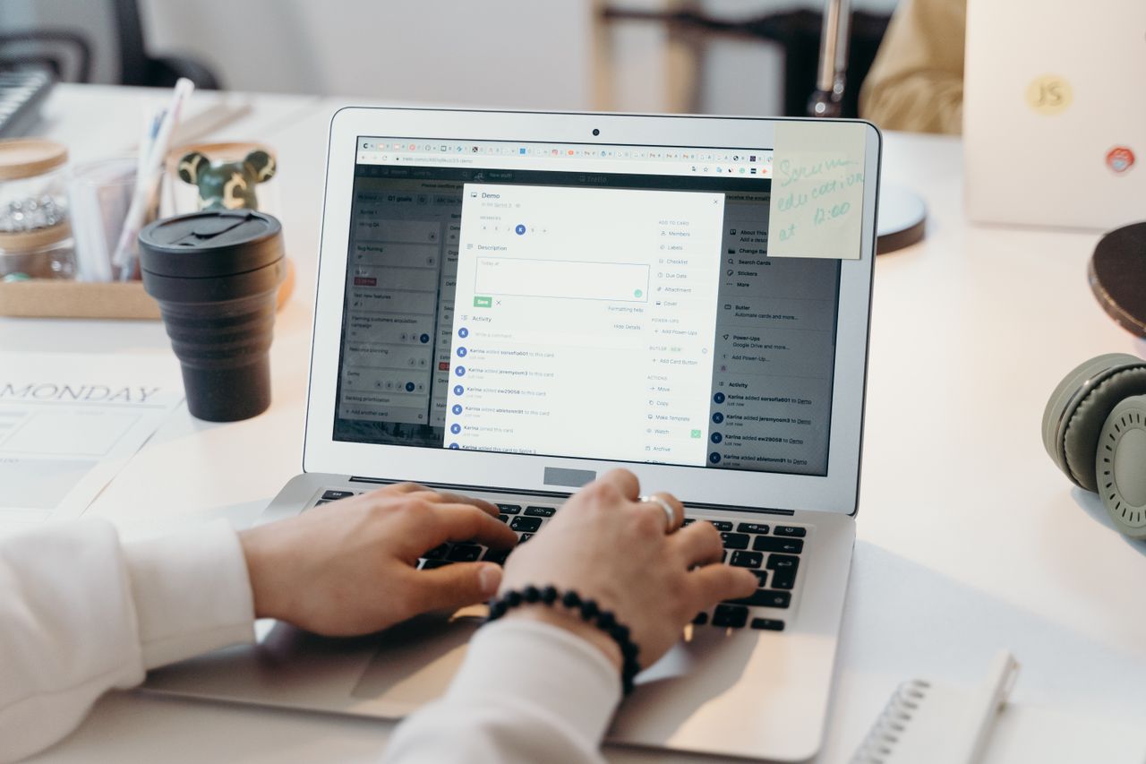 our-story A person typing on a laptop in a bright, modern office setting, showing productivity and technology.